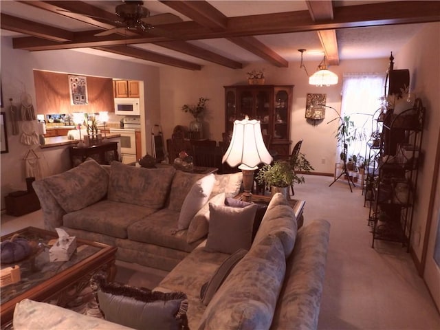 carpeted living room with ceiling fan and beam ceiling