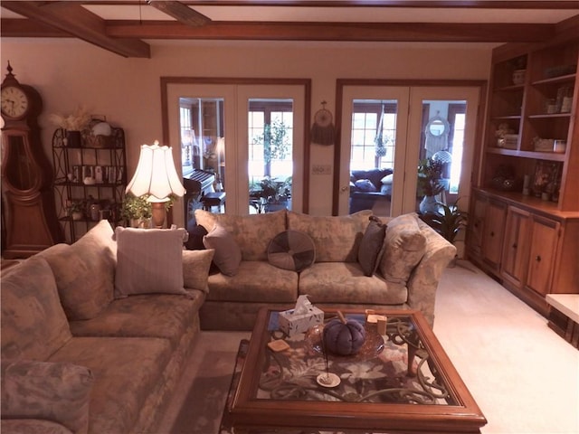 living room featuring beam ceiling and french doors