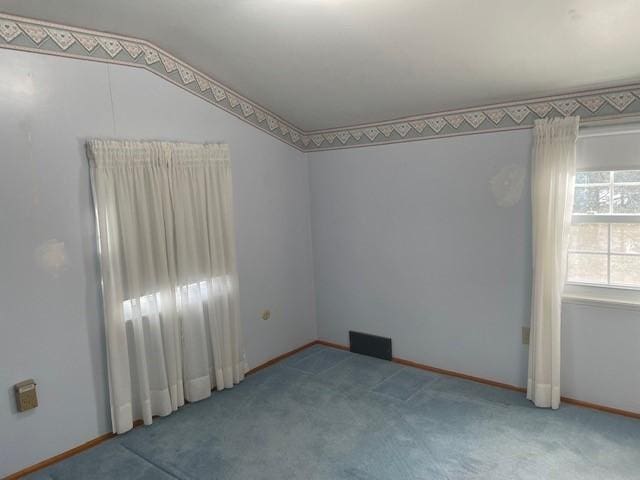 carpeted spare room with baseboards