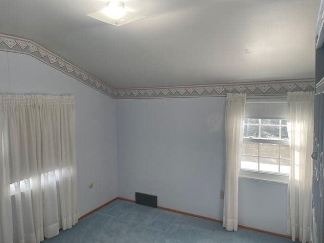 carpeted empty room with baseboards