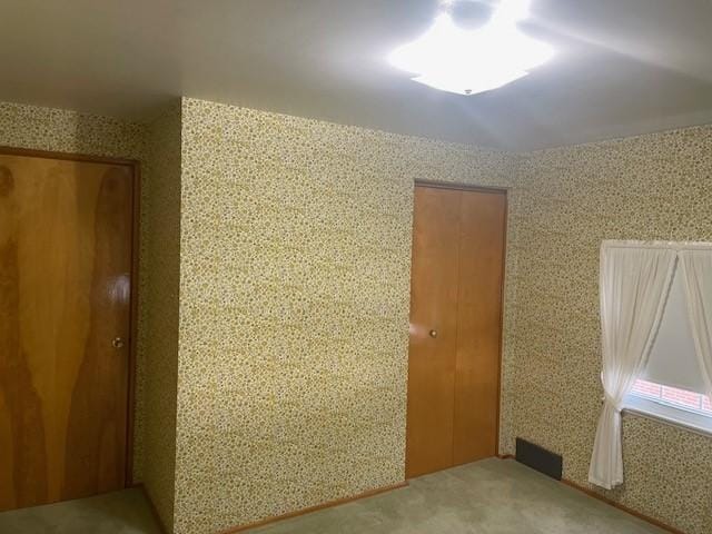 unfurnished room with light colored carpet