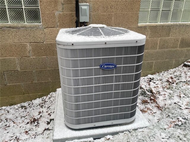 details featuring concrete block siding and central AC unit