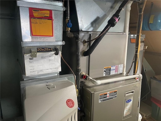 utility room featuring heating unit