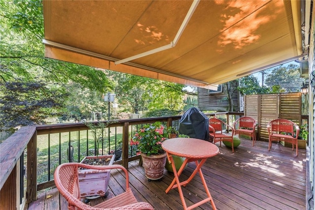 wooden terrace with a grill