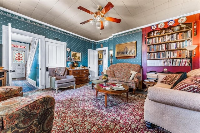 living room with ceiling fan and crown molding