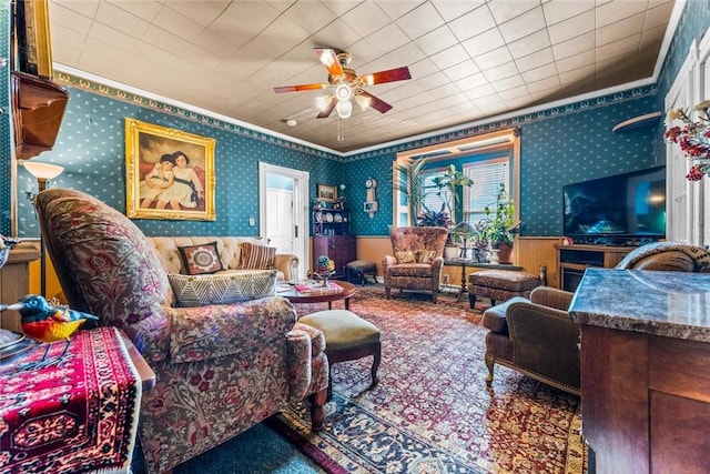 living room featuring carpet floors, ceiling fan, and crown molding