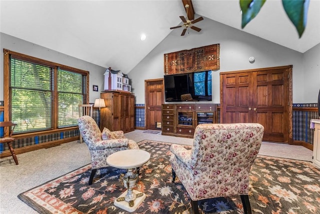 carpeted living room featuring beamed ceiling, high vaulted ceiling, and ceiling fan