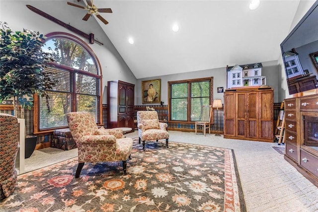 living area with light carpet, high vaulted ceiling, and a wealth of natural light