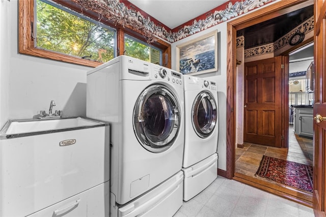 clothes washing area featuring washer and clothes dryer