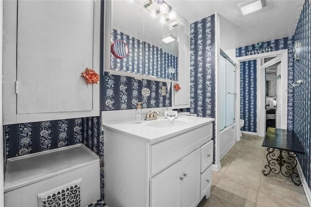 bathroom with vanity and enclosed tub / shower combo