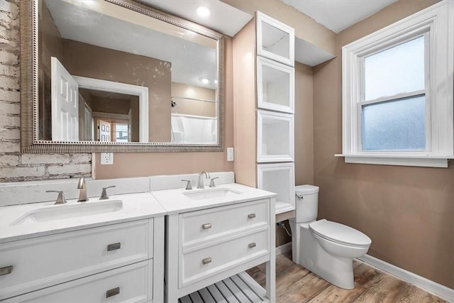 bathroom with hardwood / wood-style floors, vanity, and toilet