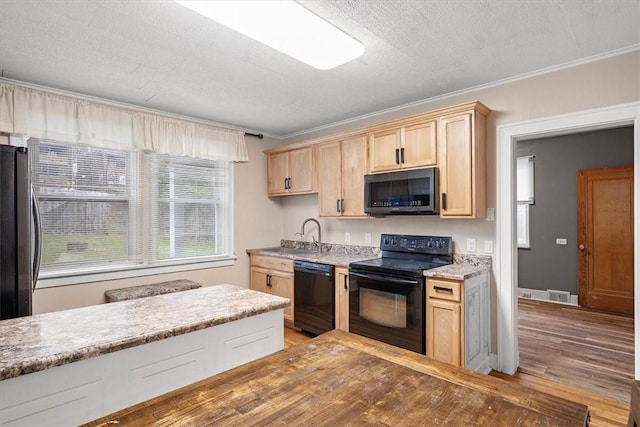 kitchen with black appliances, light brown cabinets, crown molding, and sink