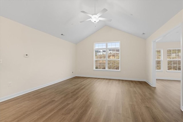 unfurnished living room with ceiling fan, hardwood / wood-style floors, and lofted ceiling