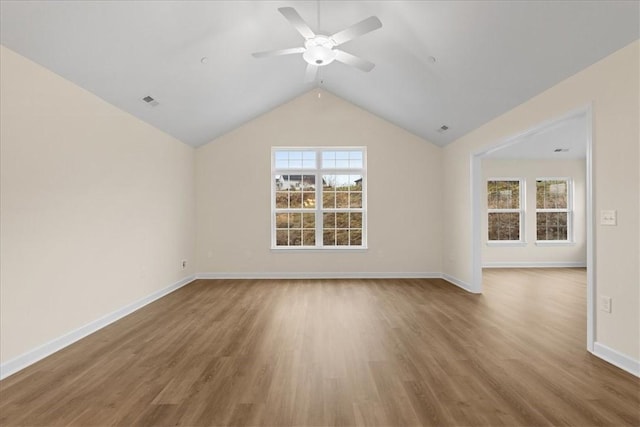 unfurnished living room featuring hardwood / wood-style flooring, vaulted ceiling, and ceiling fan