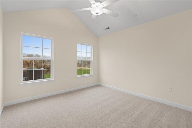 carpeted spare room with ceiling fan and lofted ceiling