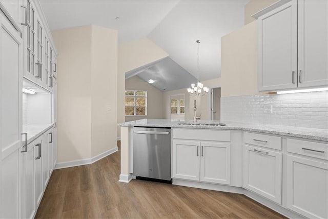 kitchen with white cabinets, vaulted ceiling, sink, dishwasher, and light hardwood / wood-style floors