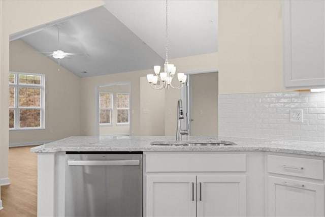 kitchen featuring white cabinetry, sink, a healthy amount of sunlight, stainless steel dishwasher, and lofted ceiling