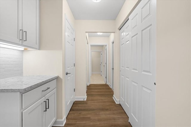 hallway with dark hardwood / wood-style floors