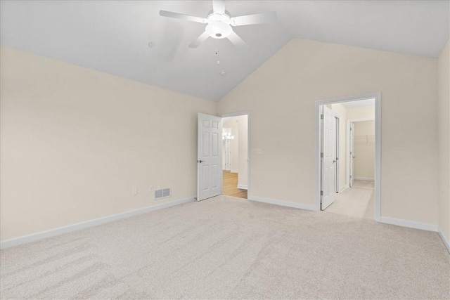 unfurnished bedroom featuring ceiling fan, light colored carpet, and lofted ceiling