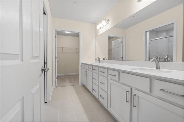 bathroom with tile patterned flooring, vanity, and a shower with shower door