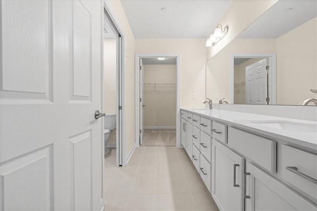 bathroom with tile patterned flooring, vanity, and toilet