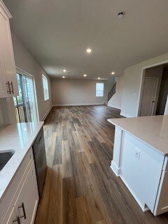 interior space with light stone counters, white cabinets, and stainless steel dishwasher