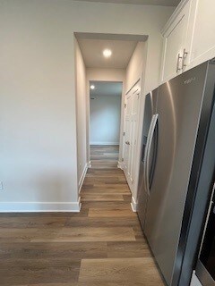 corridor featuring dark hardwood / wood-style floors