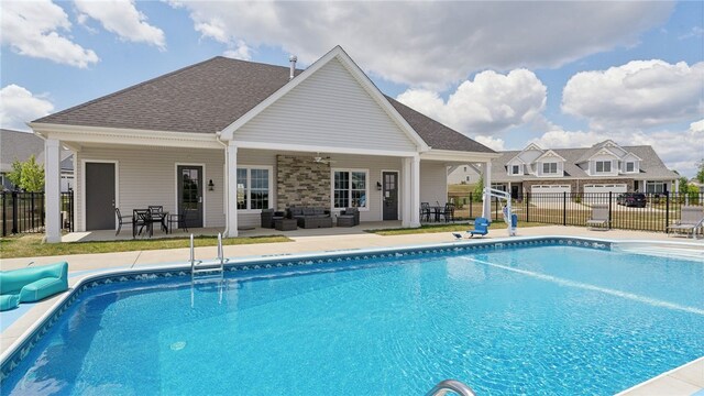 view of pool featuring ceiling fan, a patio area, and an outdoor living space