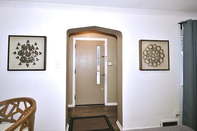 entryway featuring dark hardwood / wood-style flooring and ornamental molding