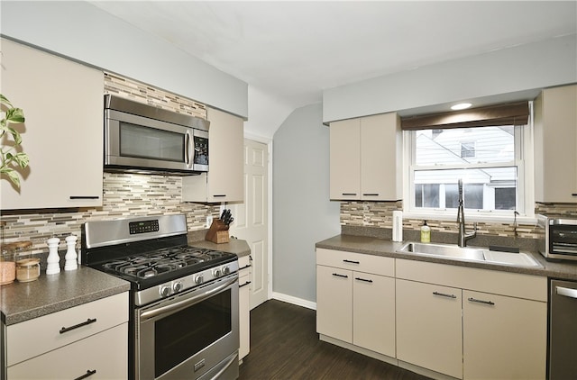 kitchen featuring sink, dark hardwood / wood-style floors, backsplash, white cabinets, and appliances with stainless steel finishes