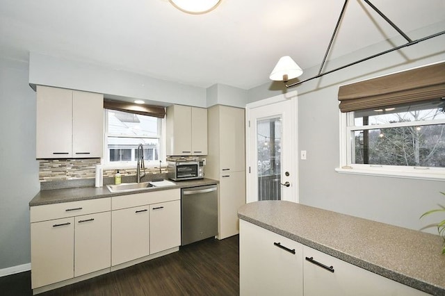 kitchen with dishwasher, dark hardwood / wood-style flooring, tasteful backsplash, and sink