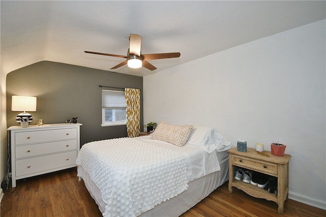 bedroom with dark hardwood / wood-style flooring, vaulted ceiling, and ceiling fan