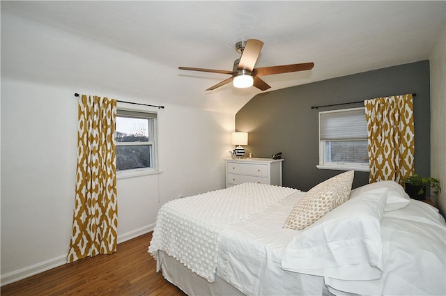 bedroom with hardwood / wood-style floors, vaulted ceiling, and ceiling fan