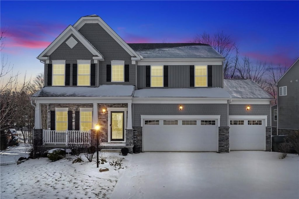 view of front of house with a porch and a garage