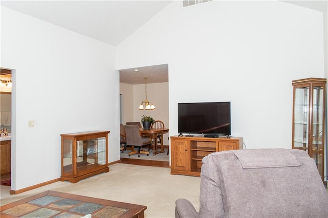 living room with light colored carpet, high vaulted ceiling, and an inviting chandelier