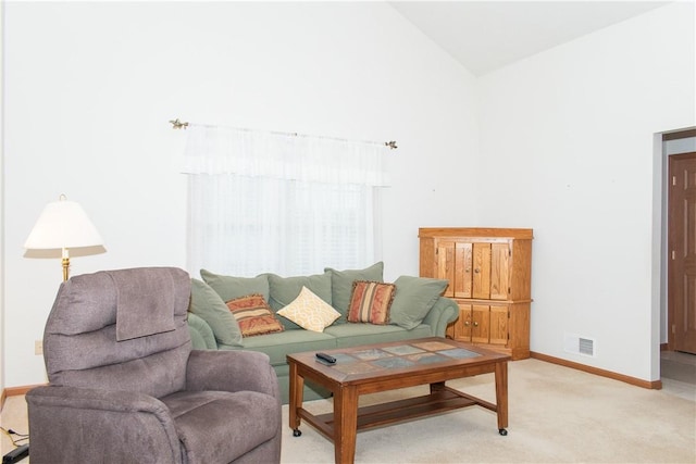 living room featuring high vaulted ceiling and light colored carpet