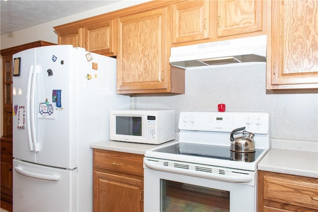 kitchen with white appliances and a textured ceiling