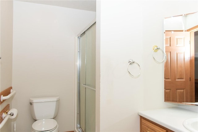 bathroom with vanity, toilet, and an enclosed shower