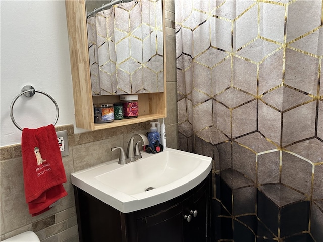 bathroom featuring vanity and tile walls