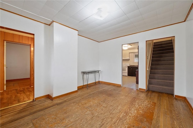 unfurnished room featuring hardwood / wood-style floors and ornamental molding