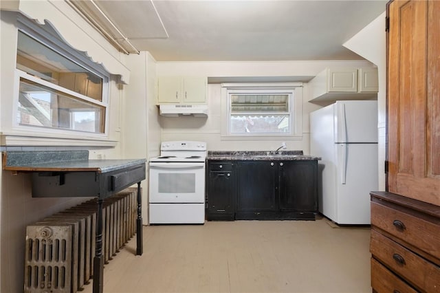 kitchen featuring white appliances, sink, light wood-type flooring, tasteful backsplash, and white cabinetry