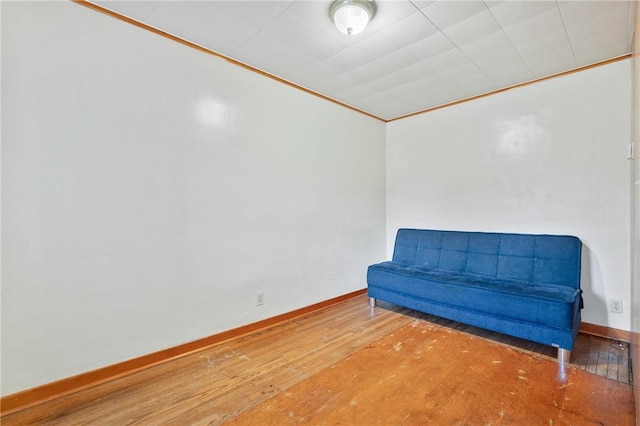 unfurnished room featuring crown molding and wood-type flooring