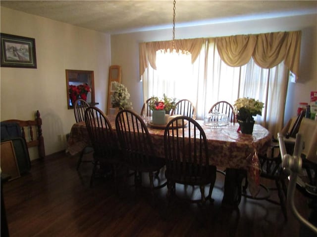 dining space with a chandelier and dark hardwood / wood-style floors