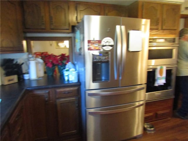 kitchen featuring dark hardwood / wood-style flooring and stainless steel appliances