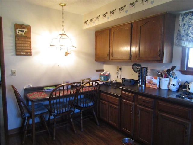 kitchen featuring dark hardwood / wood-style flooring and decorative light fixtures