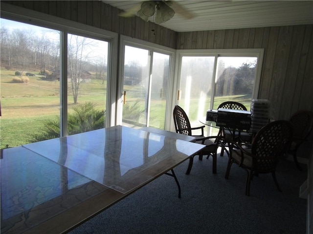 sunroom / solarium featuring ceiling fan and a healthy amount of sunlight