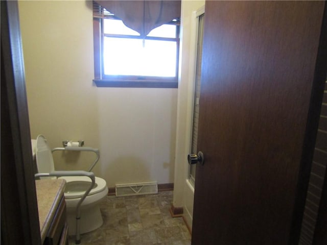 bathroom with a shower, vanity, and toilet