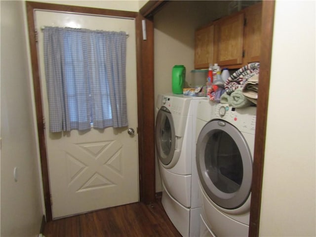 washroom featuring cabinets, independent washer and dryer, and dark wood-type flooring