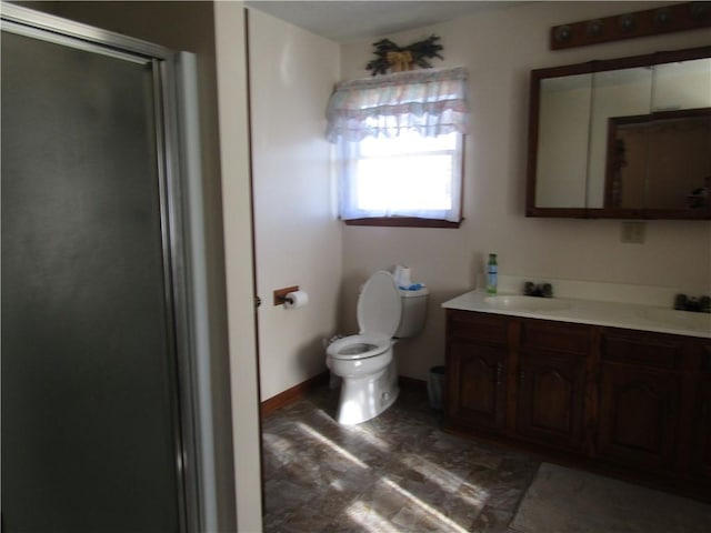 bathroom featuring vanity, toilet, and an enclosed shower