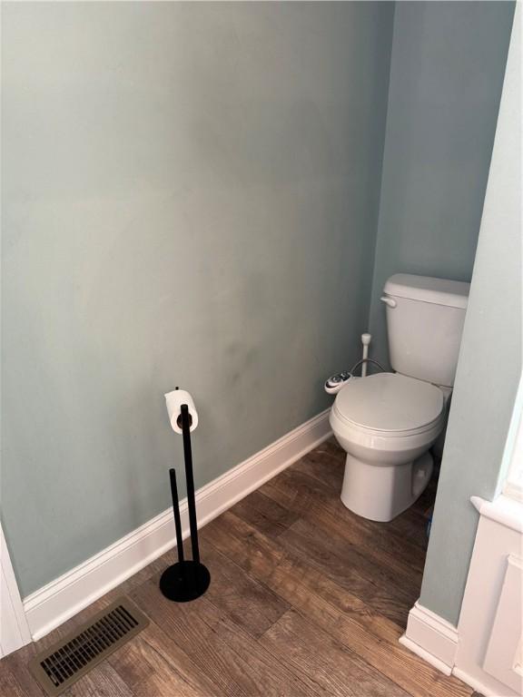 bathroom featuring hardwood / wood-style flooring and toilet